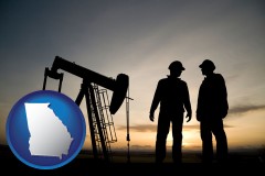 georgia map icon and an oil well and two oil workers at dusk