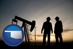 oklahoma map icon and an oil well and two oil workers at dusk