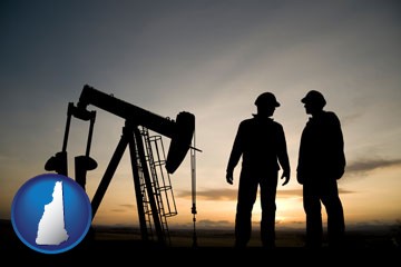 an oil well and two oil workers at dusk - with New Hampshire icon