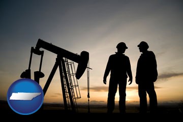 an oil well and two oil workers at dusk - with Tennessee icon